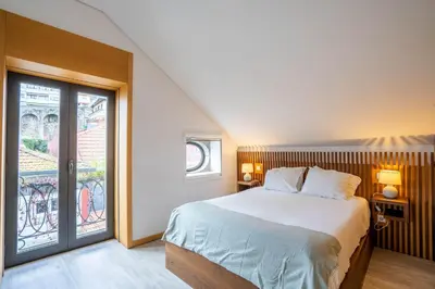 a bedroom with a bed and a large window at Smartr Porto Reis de Gaia & Spa in Vila Nova de Gaia