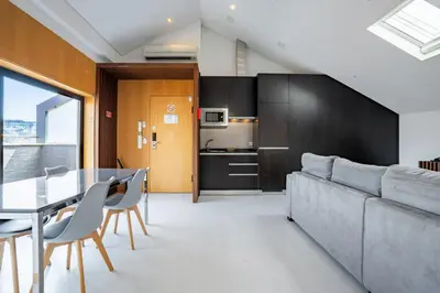 a living room with a couch and a table at Smartr Porto Reis de Gaia & Spa in Vila Nova de Gaia
