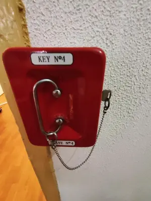 a red phone is attached to a wall at Porto Chique AL 4 in Porto
