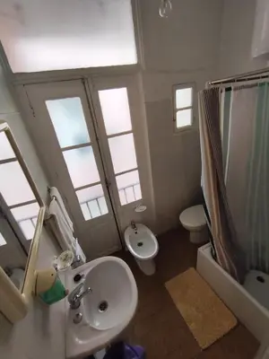 a bathroom with a sink and a toilet and windows at Porto Chique AL 4 in Porto
