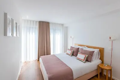 a bedroom with a large bed with two pillows at Porto Cozy and Design Apartment in Porto Center in Porto