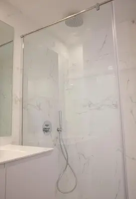 a shower with a glass door in a bathroom at Porto Cozy and Design Apartment in Porto Center in Porto