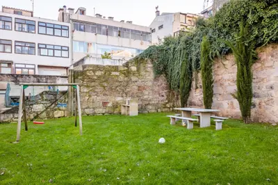 a park with a bench and a basketball hoop at Porto Cozy and Design Apartment in Porto Center in Porto
