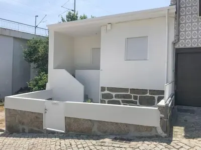 a white building with a staircase on the side of it at Casa da fonte in Vila Nova de Gaia