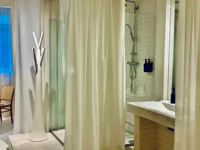 a bathroom with a shower curtain and a sink at DEUXMECS Porto in Porto