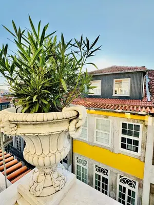 a large stone urn in front of a building at DEUXMECS Porto in Porto