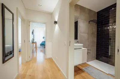 a bathroom with a sink and a mirror at 24 Agosto Amazing Triplex by Vacationy in Porto