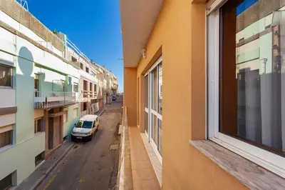 a car parked on a street between two buildings at Guilhermina's Place in Vila Nova de Gaia
