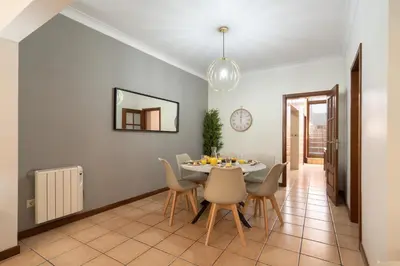 a dining room with a table and chairs at Host Wise - Spacious Duplex House - Jacuzzi & Terrace in Porto