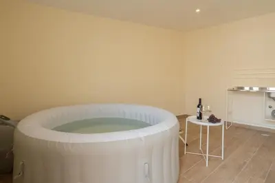 a room with a large white tub in a room at Host Wise - Spacious Duplex House - Jacuzzi & Terrace in Porto