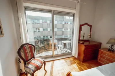 a bedroom with a window with a view of a balcony at Downtown Aquarelle by Vacationy in Porto