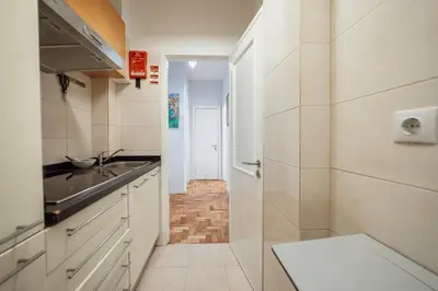a small kitchen with a sink and a counter at Downtown Aquarelle by Vacationy in Porto