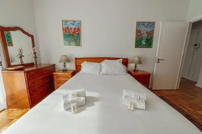 a bedroom with a large white bed and a mirror at Downtown Aquarelle by Vacationy in Porto