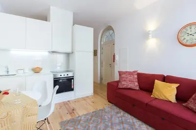 a living room with a red couch and a table at Host Wise - Spacious Bright Flat - Terrace in Porto