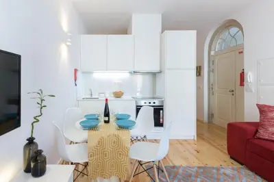 a kitchen and living room with a table and chairs at Host Wise - Spacious Bright Flat - Terrace in Porto