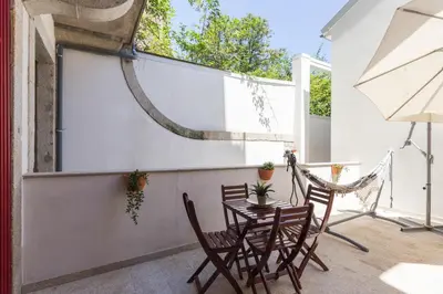a patio with a table and chairs and a projection screen at Host Wise - Spacious Bright Flat - Terrace in Porto
