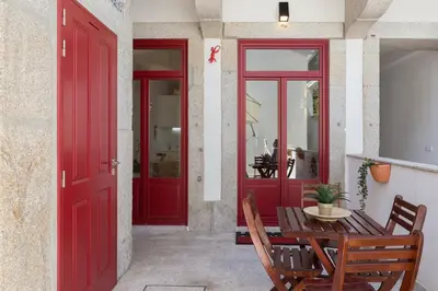 a dining room with red doors and a table and chairs at Host Wise - Spacious Bright Flat - Terrace in Porto