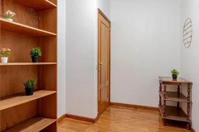 a hallway with wooden shelves and a door at Host Wise - Rustic Bright Flat - City Centre in Porto