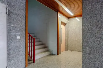 a hallway with a staircase in a building at Host Wise - Rustic Bright Flat - City Centre in Porto