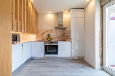 a kitchen with white cabinets and a stove at Host Wise - Modern Comfy Flat in Porto