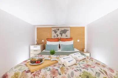 a bedroom with a bed with a tray of food on it at Host Wise - Deluxe Spacious Flats w Mezzanine in Porto