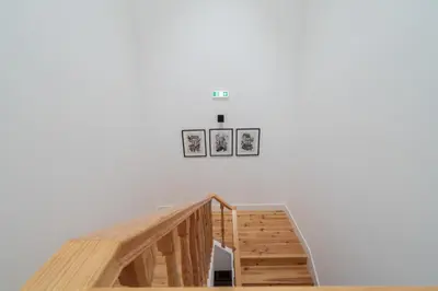 a staircase in a white wall with three pictures on the wall at Host Wise - Modern Design Duplex w Balcony in Porto