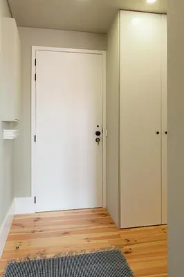 a room with a white door and a wooden floor at Host Wise - Modern Design Duplex w Balcony in Porto