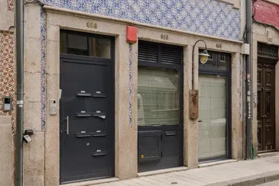two black doors on the side of a building at Host Wise - Modern Design Duplex w Balcony in Porto