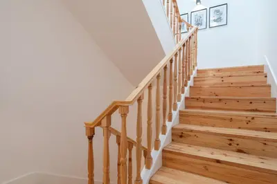a staircase in a home with wooden floors at Host Wise - Modern Design Duplex w Balcony in Porto