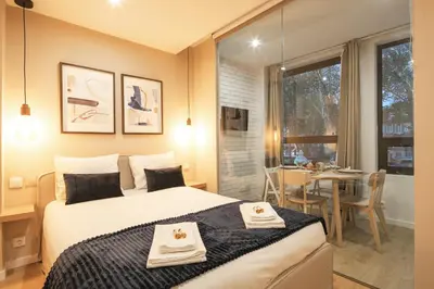 a bedroom with a bed and a dining room with a table at Marquês Oporto Apartment in Porto