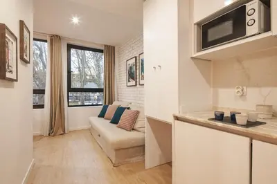 a living room with a couch and a microwave at Marquês Oporto Apartment in Porto