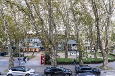 a group of cars parked in a parking lot with trees at Marquês Oporto Apartment in Porto