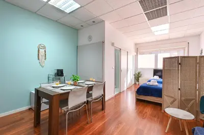 a room with a table and chairs and a bed at Coliseu Oporto Center in Porto