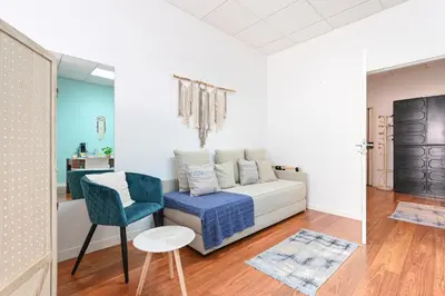 a living room with a couch and a chair at Coliseu Oporto Center in Porto