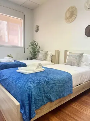 a bedroom with two beds with a blue blanket at Coliseu Oporto Center in Porto
