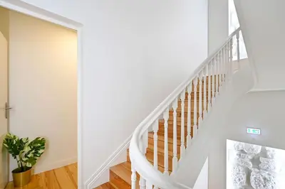 a white staircase in a house with a potted plant at Santa Catarina Oporto City Center in Porto
