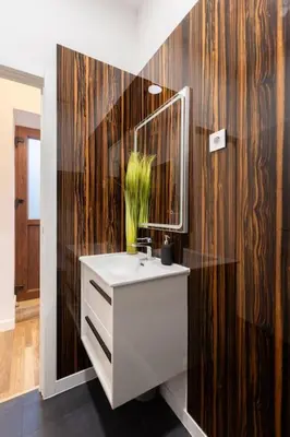 a bathroom with a white sink and a mirror at Bright apartment with garden in Porto