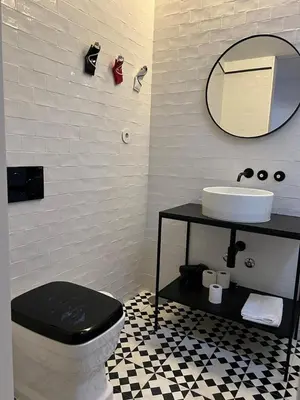 a bathroom with a toilet and a sink and a mirror at Get bindings and books on duplex in Porto