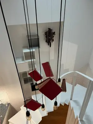 a group of red lights hanging from a ceiling at Get bindings and books on duplex in Porto