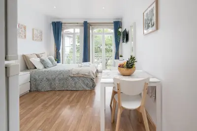 a bedroom with a bed and a table and chairs at Host Wise - Enchanting Unique Flat - Ace Location in Porto