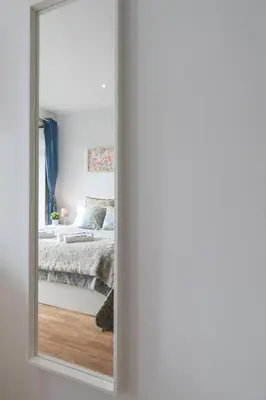 a mirror in a bedroom with a bed at Host Wise - Enchanting Unique Flat - Ace Location in Porto