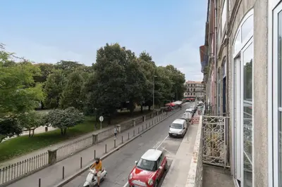 a street with cars parked on the side of a building at Host Wise - Enchanting Unique Flat - Ace Location in Porto