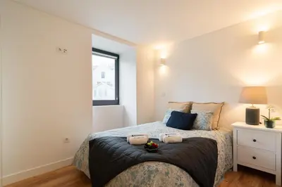 a bedroom with a bed and a window at Host Wise - Large Colourful Flats - Ace Location in Vila Nova de Gaia