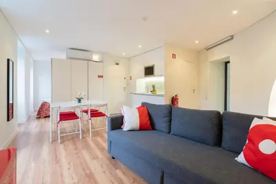 a living room with a blue couch and a table at Host Wise - Large Colourful Flats - Ace Location in Vila Nova de Gaia