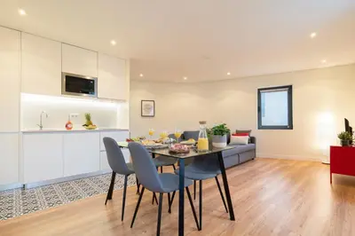 a dining room and living room with a table and chairs at Host Wise - Large Colourful Flats - Ace Location in Vila Nova de Gaia