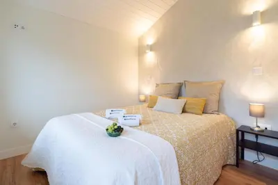 a bedroom with a large bed with yellow pillows at Host Wise - Large Colourful Flats - Ace Location in Vila Nova de Gaia