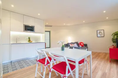 a kitchen and living room with a white table and chairs at Host Wise - Large Colourful Flats - Ace Location in Vila Nova de Gaia