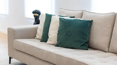 a couch with four pillows on top of it at Morro Premium Apartment w Free Parking in Vila Nova de Gaia