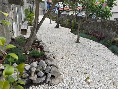 a garden with rocks and trees and a wall at Charming 2BR w Terrace & Garden in Porto