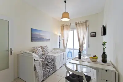 a white living room with a couch and a table at Host Wise - Sweet Flats - Bolhão City Center in Porto